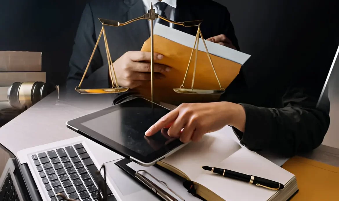 Legal professional using digital tools with justice scale, law book, and legal documents.